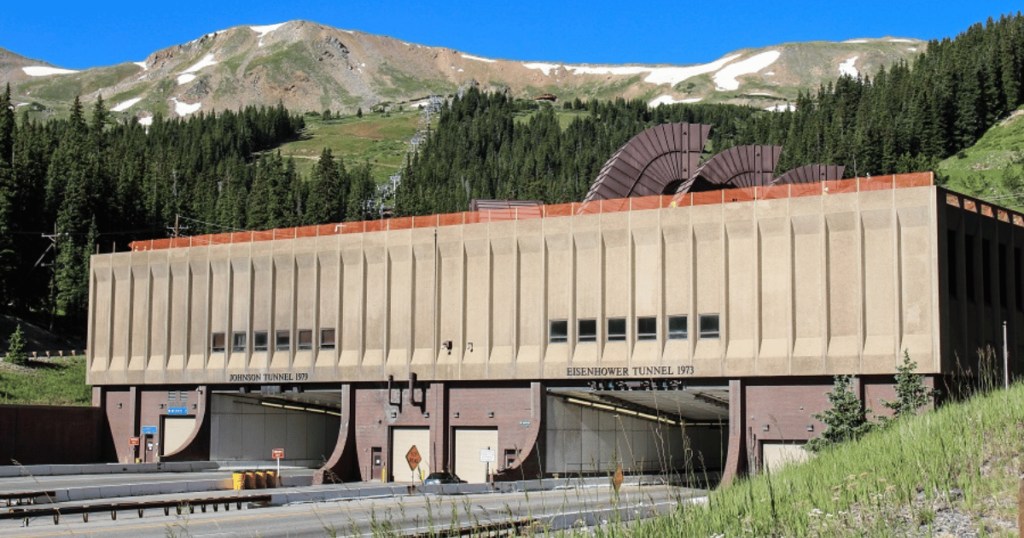 The entrance to the Eisenhower Tunnel in Colorado, USA, with surrounding Rocky Mountains.